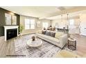 Open concept living space with fireplace, modern finishes, and seamless flow into the kitchen and dining area at 37 Mossman Ct, Zebulon, NC 27597