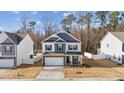 Charming two-story home with a brick facade, a two-car garage, and manicured landscaping at 3800 Cross Timber Ln, Raleigh, NC 27603