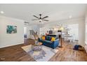 Spacious living room with a blue sofa, stylish rug, and seamless flow to the kitchen at 3800 Cross Timber Ln, Raleigh, NC 27603