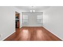 Open-concept dining room with hardwood floors and plenty of natural light from windows at 3811 Chehaw Dr, Raleigh, NC 27610