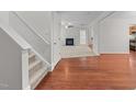 Inviting living room with hardwood floors, a cozy fireplace, and neutral paint at 3811 Chehaw Dr, Raleigh, NC 27610