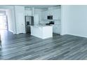Bright, open kitchen featuring white cabinets, stainless steel appliances, and a center island at 4914 Arkose Dr, Raleigh, NC 27610