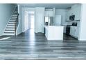 Open concept living room and kitchen with hard surface flooring at 4914 Arkose Dr, Raleigh, NC 27610
