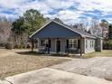 Charming single-story home featuring a covered front porch and well-maintained lawn at 5 Morning Dove Ct, Clayton, NC 27520
