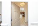 Inviting condo entrance with a chandelier and views of a modern kitchen at 528 Weather Ridge Ln, Cary, NC 27513