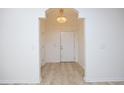 Bright foyer featuring a chandelier and attractive flooring, leading to a white door at 528 Weather Ridge Ln, Cary, NC 27513