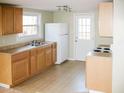 Functional kitchen featuring wood cabinets, updated appliances, and natural light streaming in from the large window at 5500 Bobbitt Rd, Apex, NC 27539
