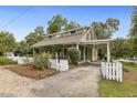 View of home with picket fence, covered entry and carport at 613 S Fuquay Ave, Fuquay Varina, NC 27526