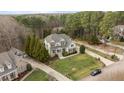 Expansive aerial view of a home nestled on a well-manicured lot with mature trees at 7709 Moondance Ct, Wake Forest, NC 27587