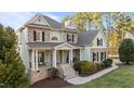 Beautiful exterior view of a two-story home with a welcoming front porch and manicured landscaping at 7709 Moondance Ct, Wake Forest, NC 27587
