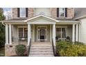 Inviting front porch with classic columns, comfortable seating, and a welcoming entrance at 7709 Moondance Ct, Wake Forest, NC 27587