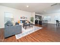 Inviting living room featuring hardwood floors, a stylish rug, and comfortable seating at 932 Peninsula Pl, Knightdale, NC 27545