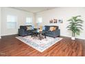 Bright living room with hardwood floors, comfortable seating, and a decorative rug at 932 Peninsula Pl, Knightdale, NC 27545