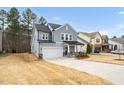 Exterior view of home with a two car garage, adjacent to lawn and other similar homes at 105 Palladium Ct, Elon, NC 27244