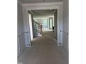 A view from the entryway showing staircase and doorway to living room area at 108 Pointe Park Cir, Holly Springs, NC 27540