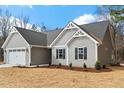 Well-maintained single story home features gray siding, black shutters, and manicured landscaping at 111 Averly Ct, Stem, NC 27581