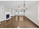 Bright living room with hardwood floors, a fireplace and large windows overlooking the backyard at 117 Woodson Dr, Clayton, NC 27527