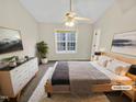 Bright main bedroom features a ceiling fan, closet, neutral walls, and natural light at 117 Woodson Dr, Clayton, NC 27527