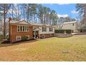 Traditional brick and siding home showcasing mature trees, well-kept lawn, and inviting curb appeal at 1203 Brookgreen Dr, Cary, NC 27511