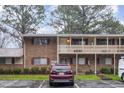 Brick exterior with a red vehicle parked in front during a rainy day at 130 S Estes Dr # F6, Chapel Hill, NC 27514