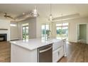 Open kitchen with a large island, stainless steel dishwasher, and views of the dining and living areas at 133 Oban Dr, Homesite 151, Sanford, NC 27330