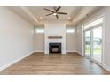 Bright living room features a modern fireplace, recessed lighting, and sliding doors to the backyard at 133 Oban Dr, Homesite 151, Sanford, NC 27330
