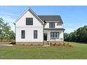 Charming new construction home with white siding, black windows, and well-kept lawn at 1467 Antioch Church Rd, Timberlake, NC 27583