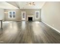 Spacious living room with hardwood floors, fireplace, and lots of natural light at 182 Inverness St, Zebulon, NC 27597