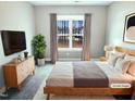Cozy bedroom with a wooden bed frame, soft bedding, and a large window at 182 Inverness St, Zebulon, NC 27597