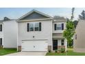 Home with white siding, black shutters, with a two-car garage, and manicured lawn at 194 Oak Barrel Rd, Smithfield, NC 27577