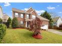 Charming two-story brick home featuring a well-manicured lawn and attached two car garage at 2017 Ollivander Dr, Cary, NC 27519