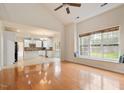 Open floor plan with hardwood floors, view into kitchen and a window seat with view at 2017 Ollivander Dr, Cary, NC 27519