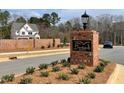 Inviting brick entrance sign for Bentwinds Bluffs community, showcasing landscaping and a glimpse of new home construction at 2313 Eagle Shot Ct # 29, Fuquay Varina, NC 27526