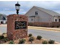 A view of Bentwinds Bluffs community entrance sign with brick landscaping and a new home in the background at 2313 Eagle Shot Ct # 29, Fuquay Varina, NC 27526