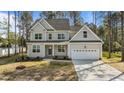 Charming two-story home with a well-maintained lawn and attached two-car garage at 25 Arbor Dr, Youngsville, NC 27596
