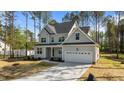 Charming two-story home with a well-maintained lawn and attached two-car garage at 25 Arbor Dr, Youngsville, NC 27596