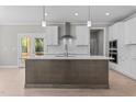 Modern kitchen featuring a center island, stainless steel appliances, and ample cabinet space at 25 Arbor Dr, Youngsville, NC 27596