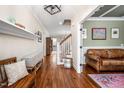Inviting entryway with hardwood floors, staircase, and stylish furnishings leading to the living area at 260 Culbreth Rd, Chapel Hill, NC 27516