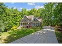 Charming two-story home with a well-manicured lawn, mature trees and an elongated drive way at 260 Culbreth Rd, Chapel Hill, NC 27516