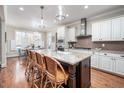 Bright kitchen features a large center island with seating, stainless steel appliances and hardwood floors at 260 Culbreth Rd, Chapel Hill, NC 27516