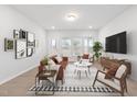 Cozy living room features modern decor, comfortable seating, and natural light at 2826 Huxley Way, Apex, NC 27502