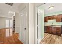 Inviting foyer with hardwood floors leading to the kitchen with stainless appliances at 3213 Coachmans Way, Durham, NC 27705