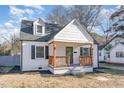 Charming two-story home featuring a cozy front porch with wooden pillars and dark shutters at 328 Cleveland St, Rocky Mount, NC 27803