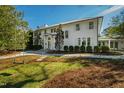 Elegant two-story home showcasing a swing and lush front yard landscaping, inviting walkway, and white exterior at 330 Tenney Circle, Chapel Hill, NC 27514