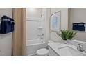Clean bathroom with a shower-tub combo, neutral paint, and modern fixtures at 415 Swift Creek Farm Ln, Clayton, NC 27520