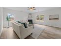 Cozy living room boasts natural light, fireplace, neutral palette and sleek flooring for a modern look at 4207 Hampstead Village Dr, Durham, NC 27703