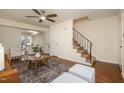 Open-concept living room featuring beautiful floors, a staircase, and ample natural light at 4705 Blue Bird Ct # C, Raleigh, NC 27606