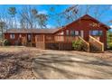 Backyard featuring an expansive wooden deck area with stairs and mature trees at 6312 New Market Way, Raleigh, NC 27615