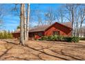 Single-Gathering home featuring an attached garage, mature trees and manicured landscaping at 6312 New Market Way, Raleigh, NC 27615