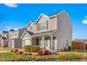 Charming two-story home with neutral siding, a one-car garage, and tidy landscaping at 642 Thistle Dr, Burlington, NC 27217